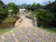 A_stone_bridge_spanning_a_small_stream_inside_the_Bonsai_Garden.jpg