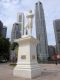 A_close-up_of_the_statue_of_Sir_Raffles_with_the_skyscrapers_of_Singapore_behind.jpg