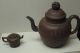 Two_Ming_Dynasty_teapots_with_one_imitating_an_ancient_bronze_drum_and_the_other_has_a_pierced_cash_knob.jpg