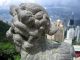 A_macro_shot_of_a_little_stone_lion_at_The_Peak_with_Victoria_Harbour_behind.jpg